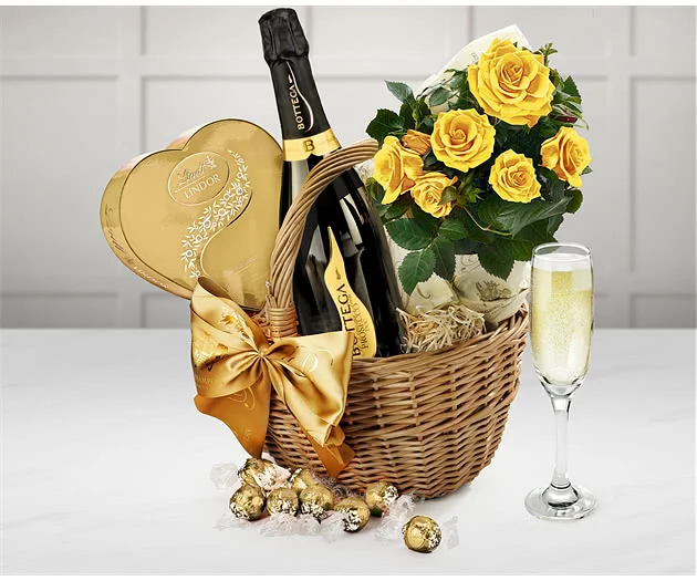 A hamper basket for a new mum with roses, chocolates and prosecco.