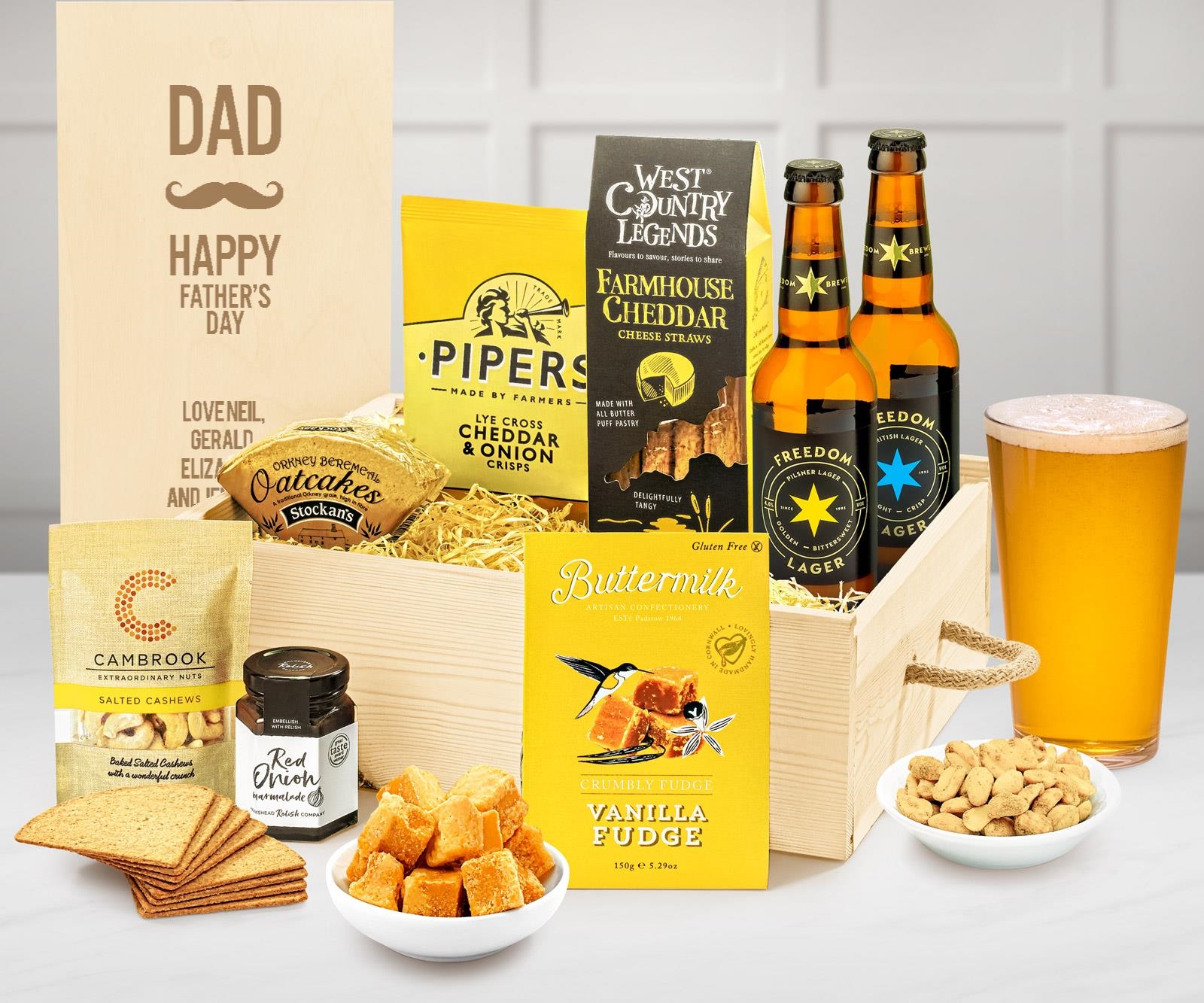 A gift crate with a personalisable lid, with lager, farmhouse cheddar, oatcakes and other treats.