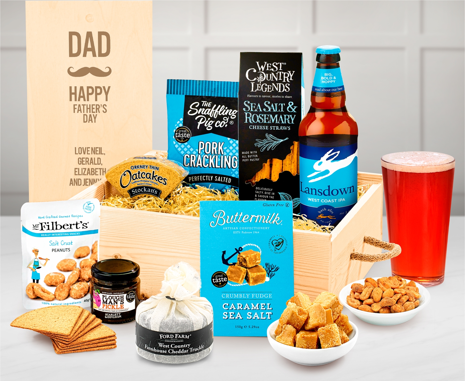 A gift crate with a personalisable lid, with real ale, pork crackling, peanuts, cheese straws and other treats.