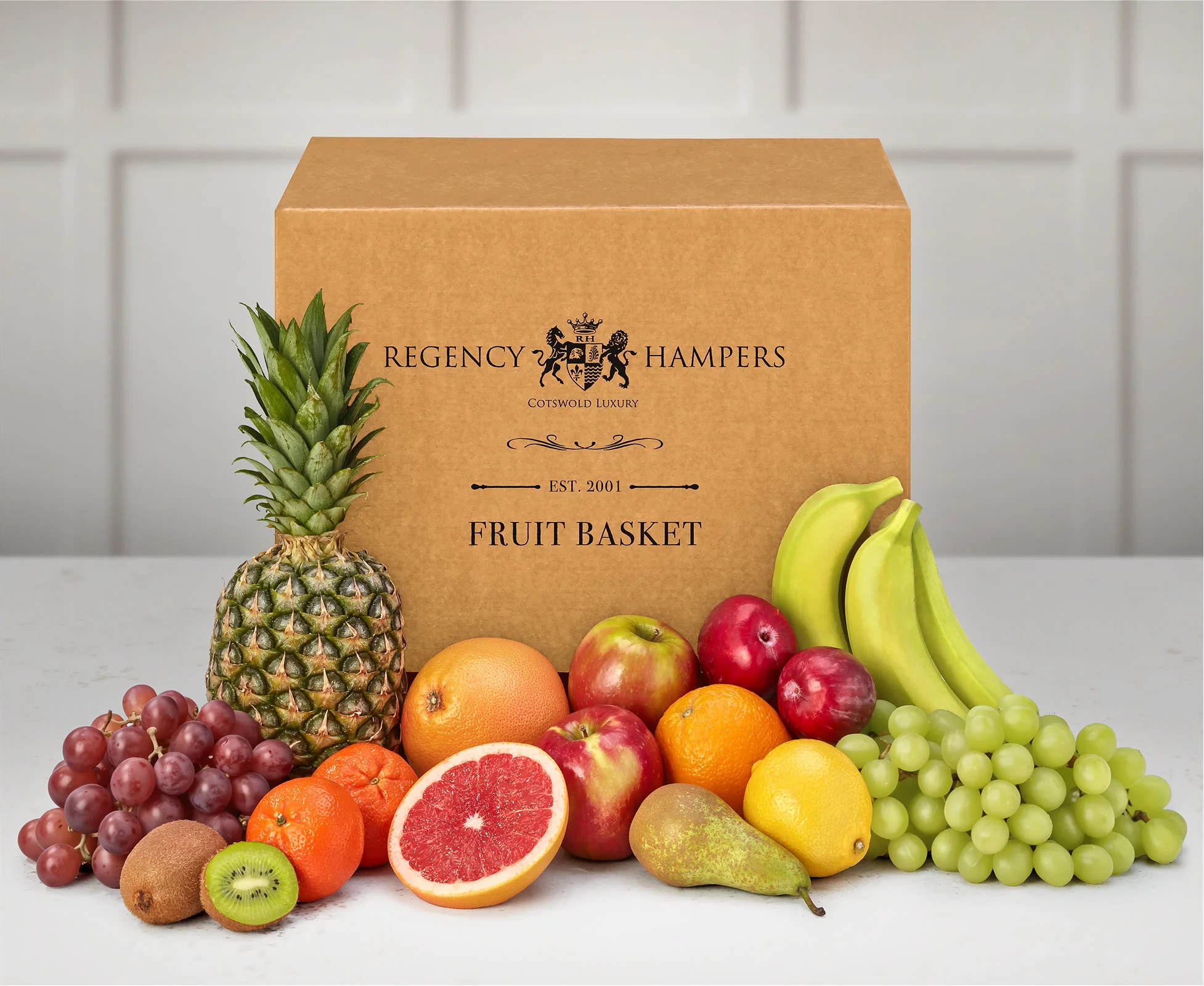 A gift box containing a variety of fresh fruits, including pineapple, grapefruit, kiiwis and bananas.