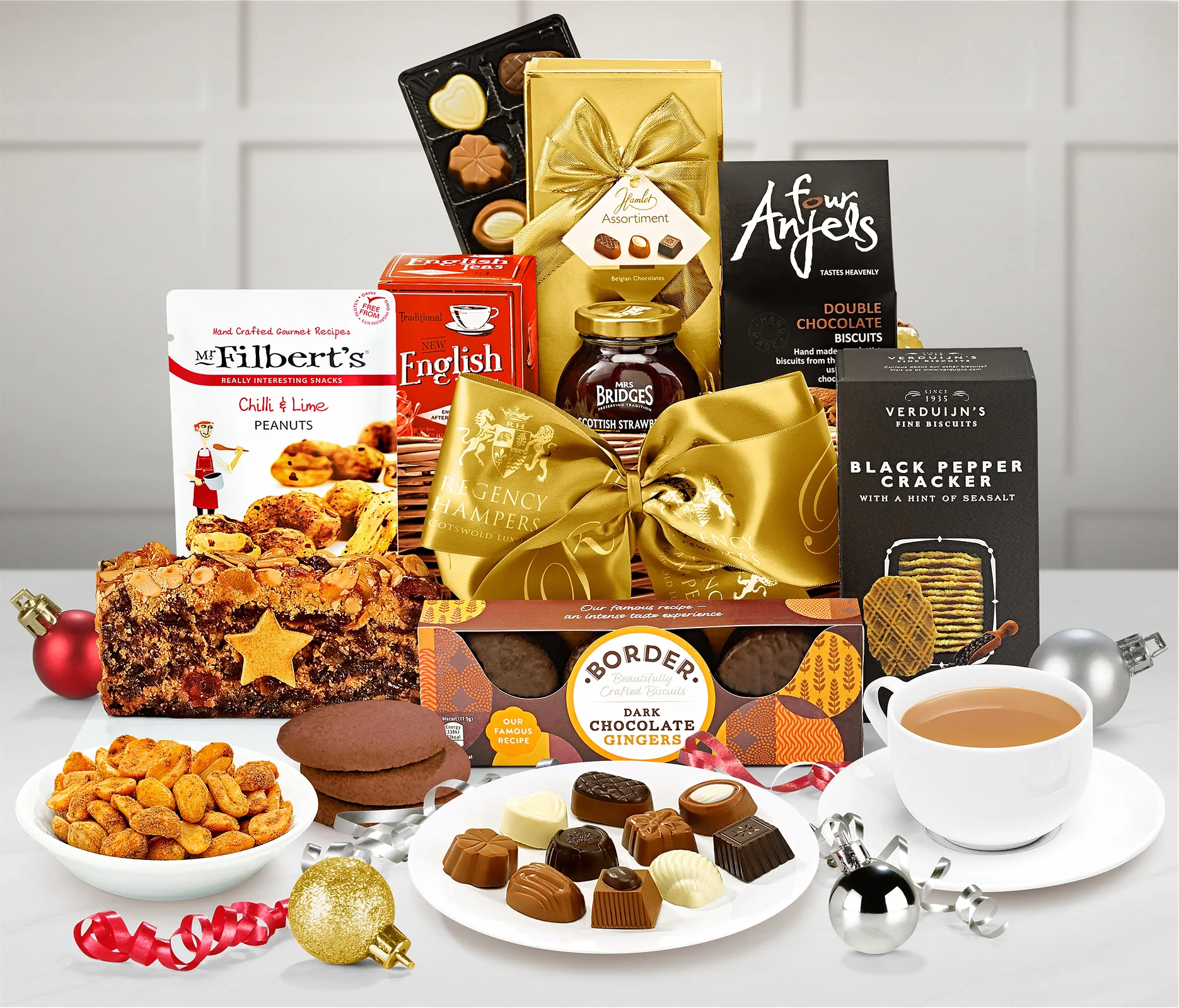 A Christmas Afternoon Tea Hamper, with a variety of biscuits, chocolates, cakes and other foods surrounding it.